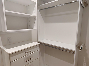 Corner section of custom closet with hanging space and drawers 