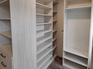 Section of walk in diy custom closet with handing space and shelves