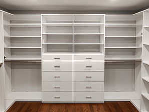Large pre built custom closet system with drawers, shelves, and hanging space